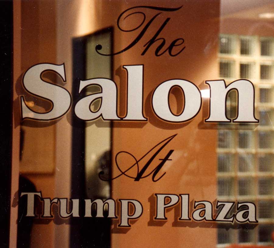 Screen printed glass of a Trump Plaza store reading 'The Salon At Trump Plaza'