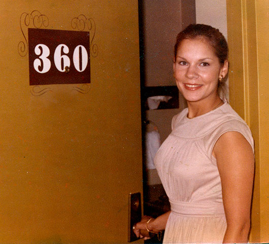 a picture of a screen printed door number (with decoration and a person next to it)